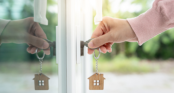 a person using a master key to open a uPVC door